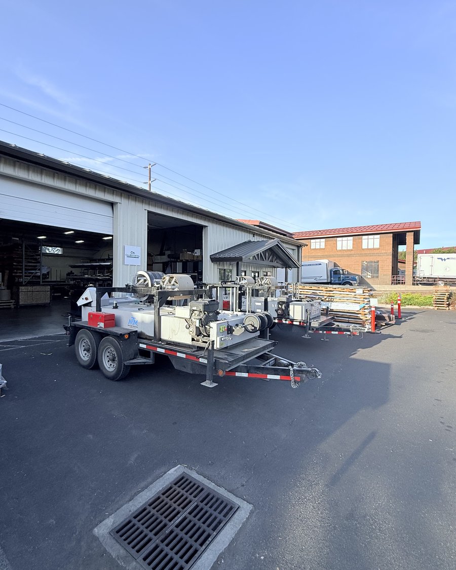Caliber Metal mobile roll-forming trailers parked outside the Bend shop