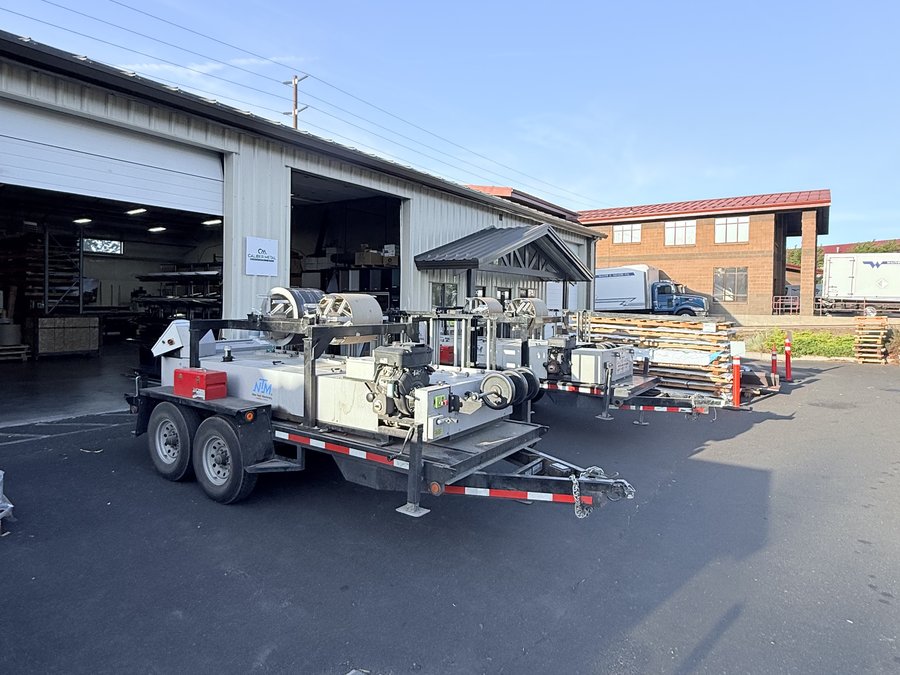 Caliber Metal mobile roll-forming trailers parked outside the Bend shop