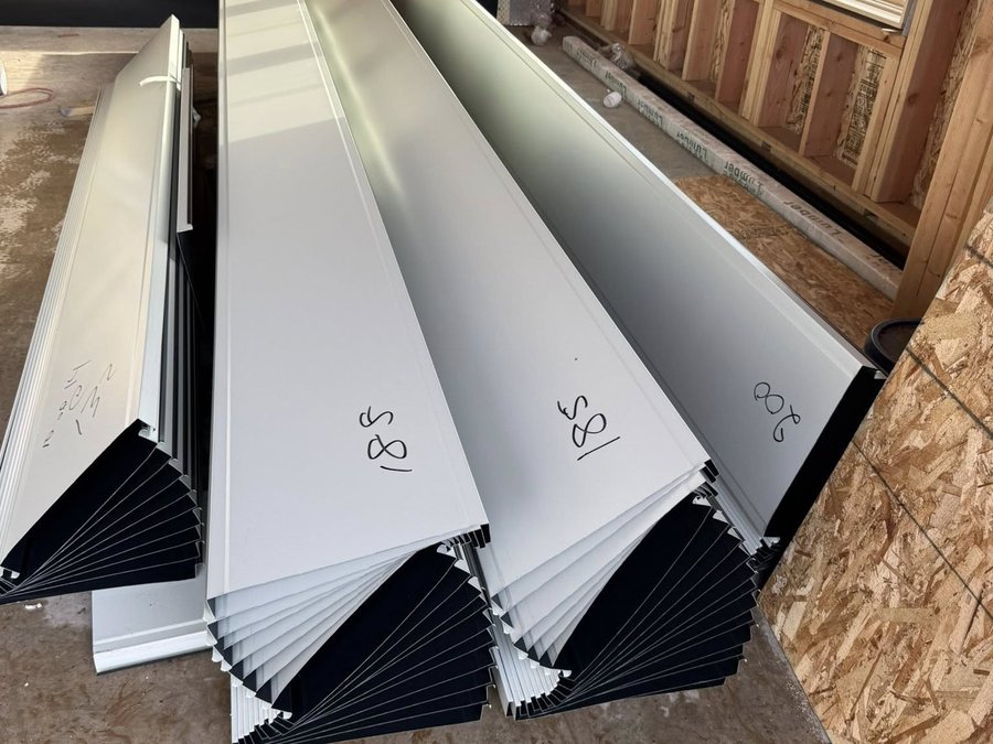 Custom white trim profiles staged inside a building